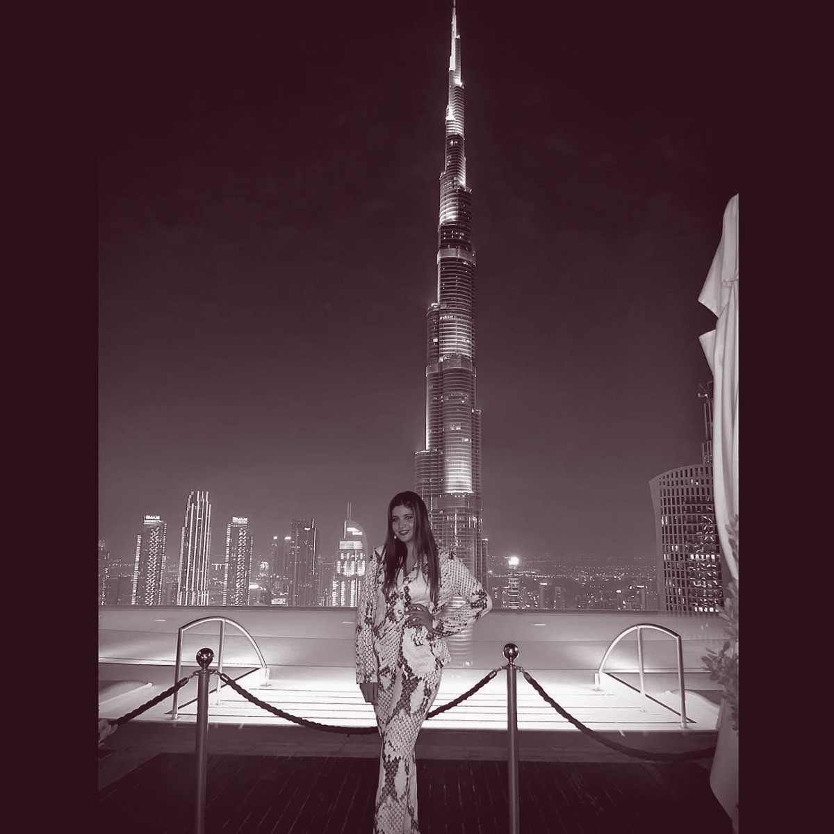 Aanchal Bohra at night in front of the illuminated Burj Khalifa